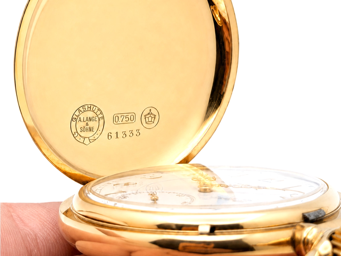 Gold case back with maker hallmarks, serial number 61333, and 0.750 fineness mark engraved.