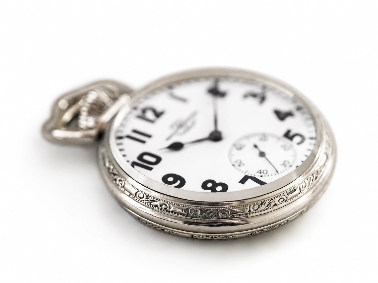 Silver pocket watch with white dial, black Arabic numerals, subsecond dial, and decorative bezel.