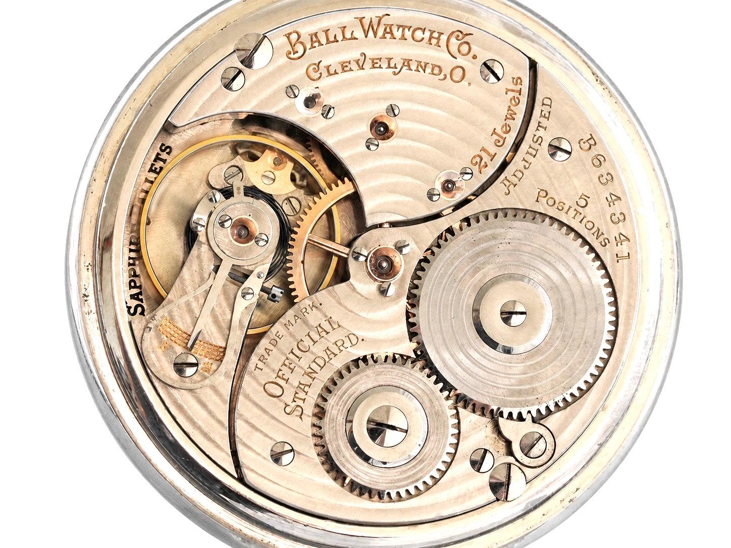 Open movement showing exposed gears, jewels, and engraved plate with maker and serial details.