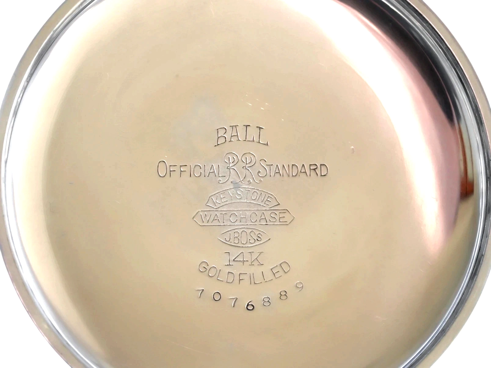Polished case back engraved with Ball Official Railroad Standard markings and 14K gold-filled hallmark.