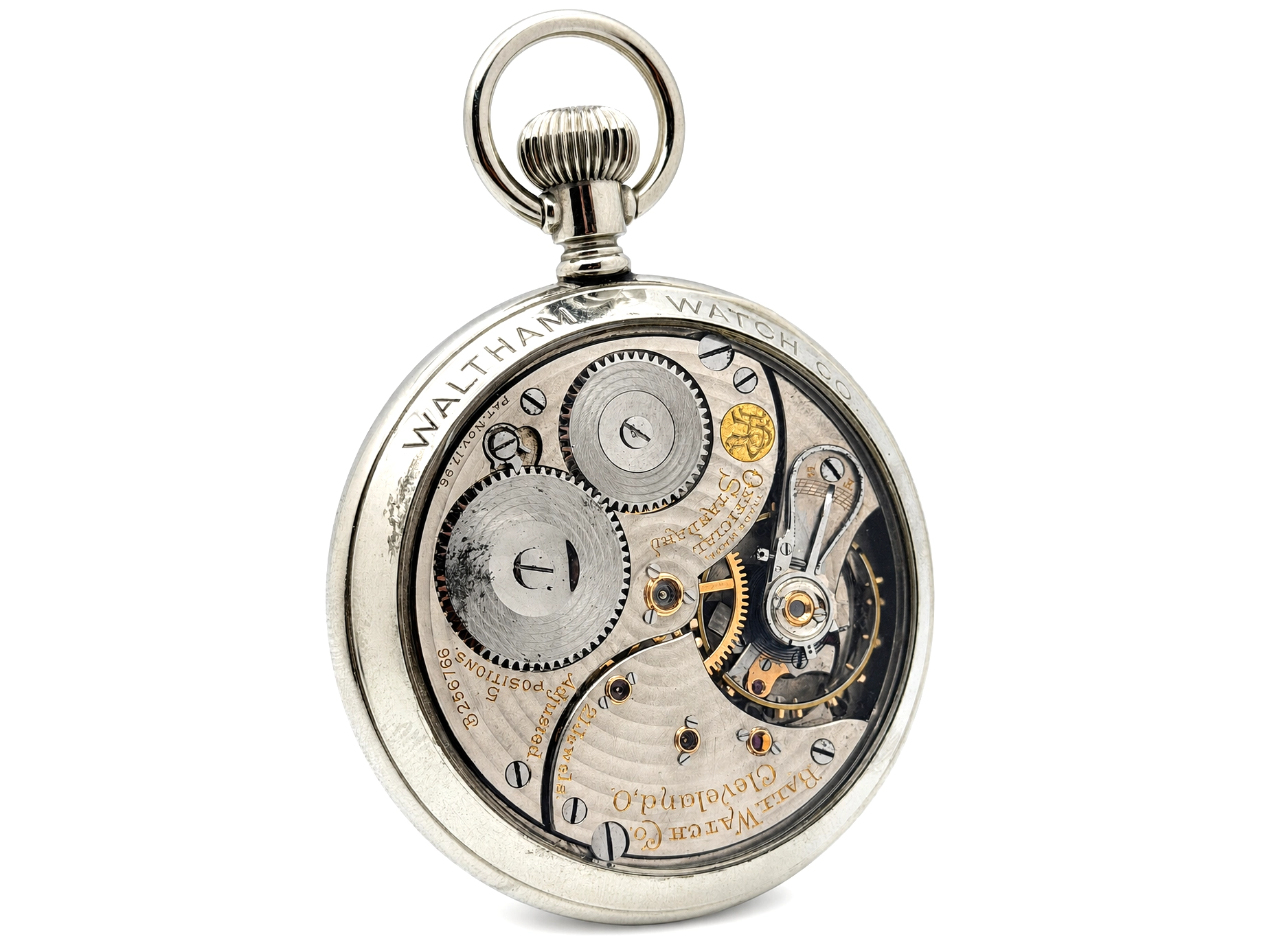Open caseback revealing exposed gear train with balance wheel and gold-jeweled escapement on silvered plates.