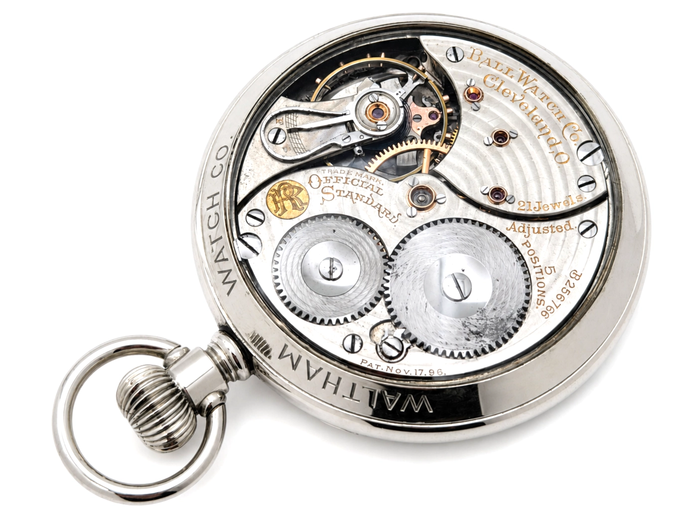 Open pocket watch movement showing dual barrels, large gears, and engraved balance cock with three jewels.