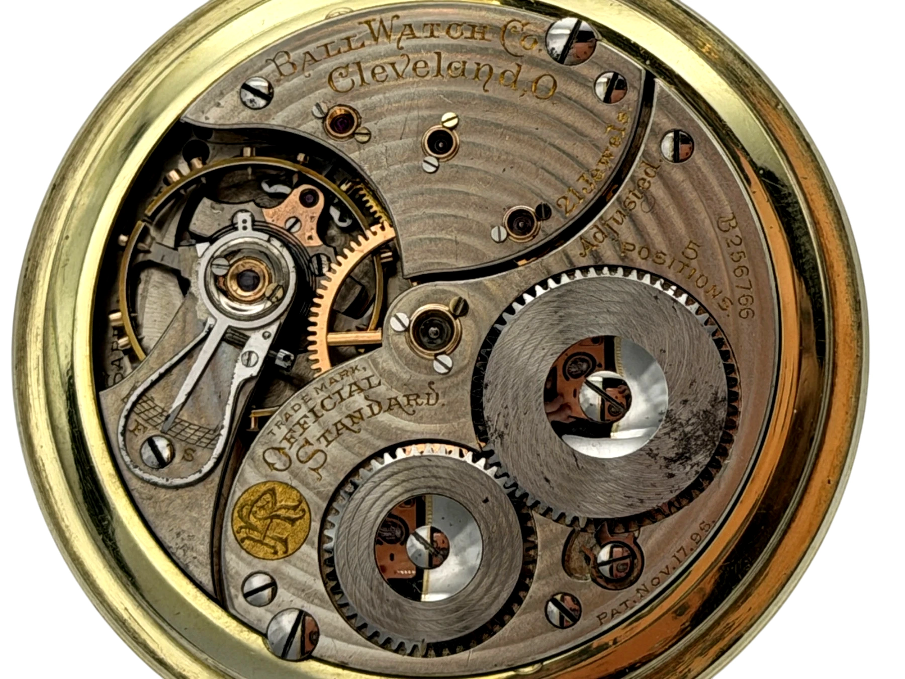 Open pocket watch movement showing Ball Watch Co Cleveland bridge with jewels and gear train visible.