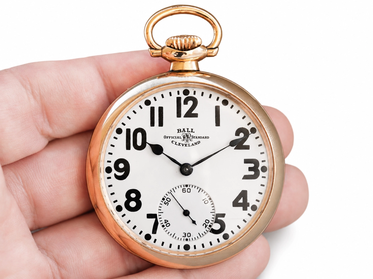 Rose gold pocket watch with white enamel dial, Arabic numerals, and subsidiary seconds dial.