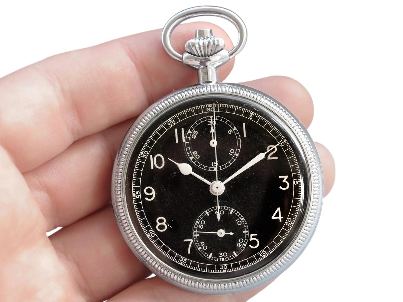 Chronograph pocket watch with black dial, Arabic numerals, two subdials, and luminous hands held in hand.