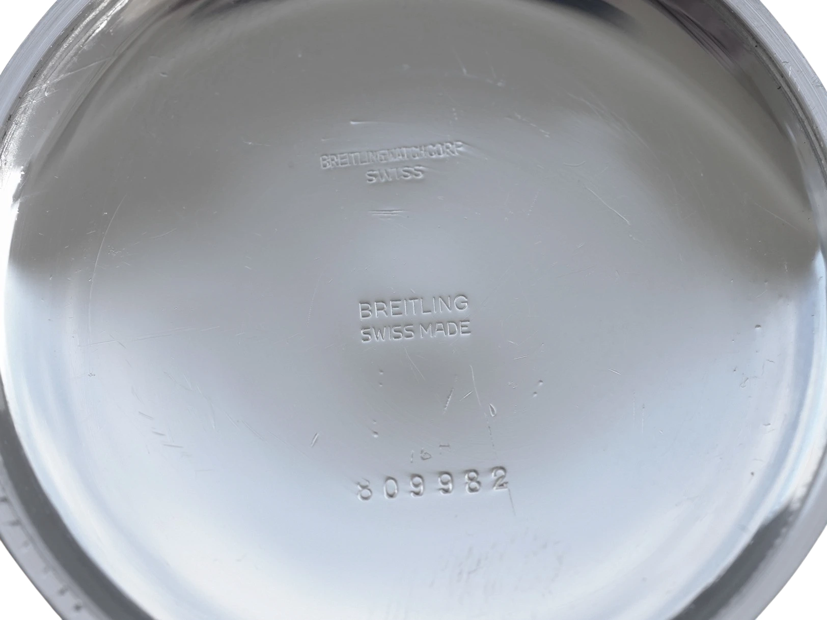 Watch case back engraved with Breitling and Swiss Made hallmarks plus serial number 809982.