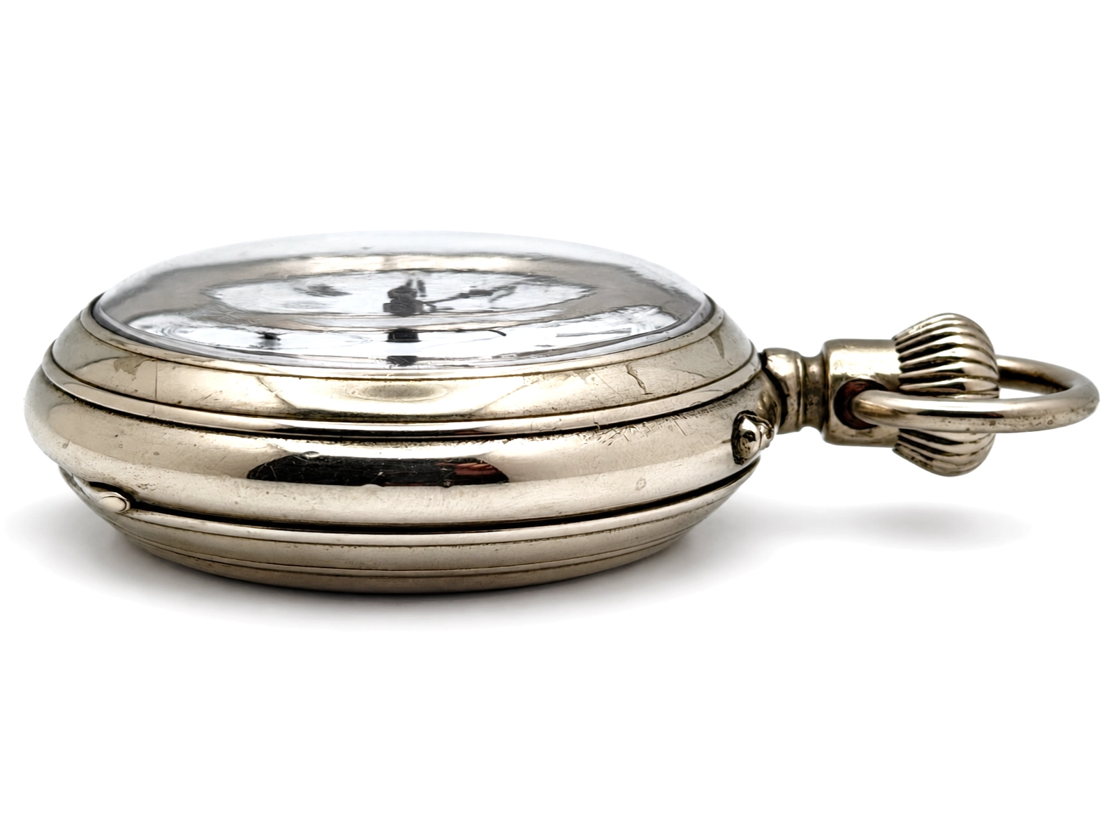 Swiss Cross Beguelin Inner Display Back (1890) — closed case viewed three-quarters, showing polished rounded sides, hinged bow, and white…