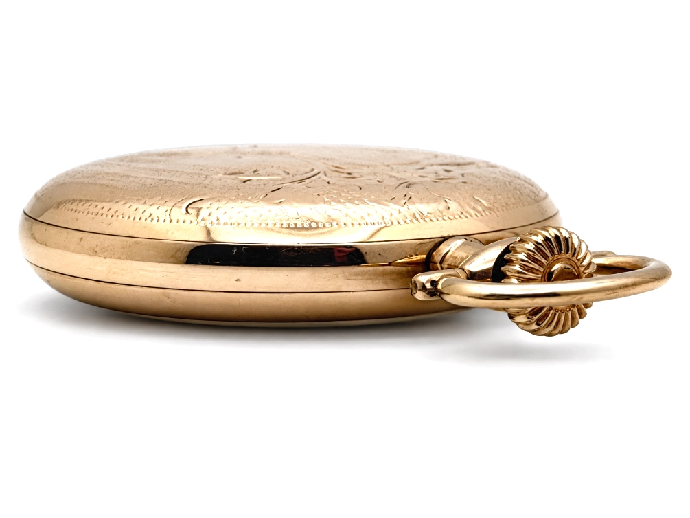 Elgin Father Time Grade 388 — closed case back with engraved design, shell-form bow attachment visible from side