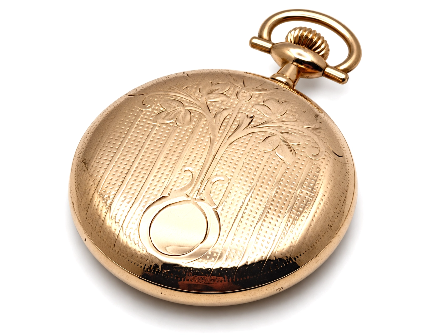 Elgin Father Time Grade 388 — closed case back showing ornamental engraving with floral and linear motifs, wear on lower edge