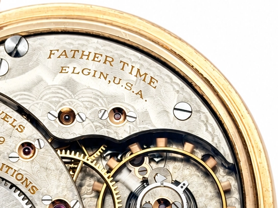 Elgin Father Time Grade 388 — open movement showing ornate damaskeening on plates and bridges, winding wheels with star patterns, jewels,…