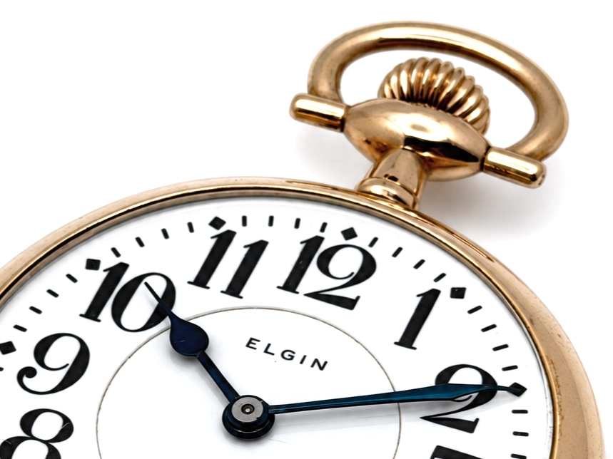 Elgin Father Time Grade 388 — openface case with white enamel dial, arabic numerals, blued steel hands, and "ELGIN" text visible at center