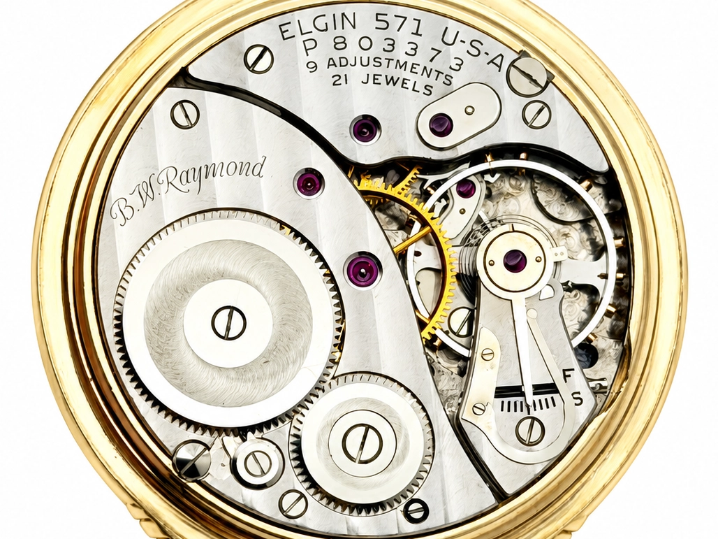 Elgin B.W. Raymond 571 Montgomery Dial (1953) — open movement showing decorated wheels, ruby jewels, and brass balance cock with engraved…