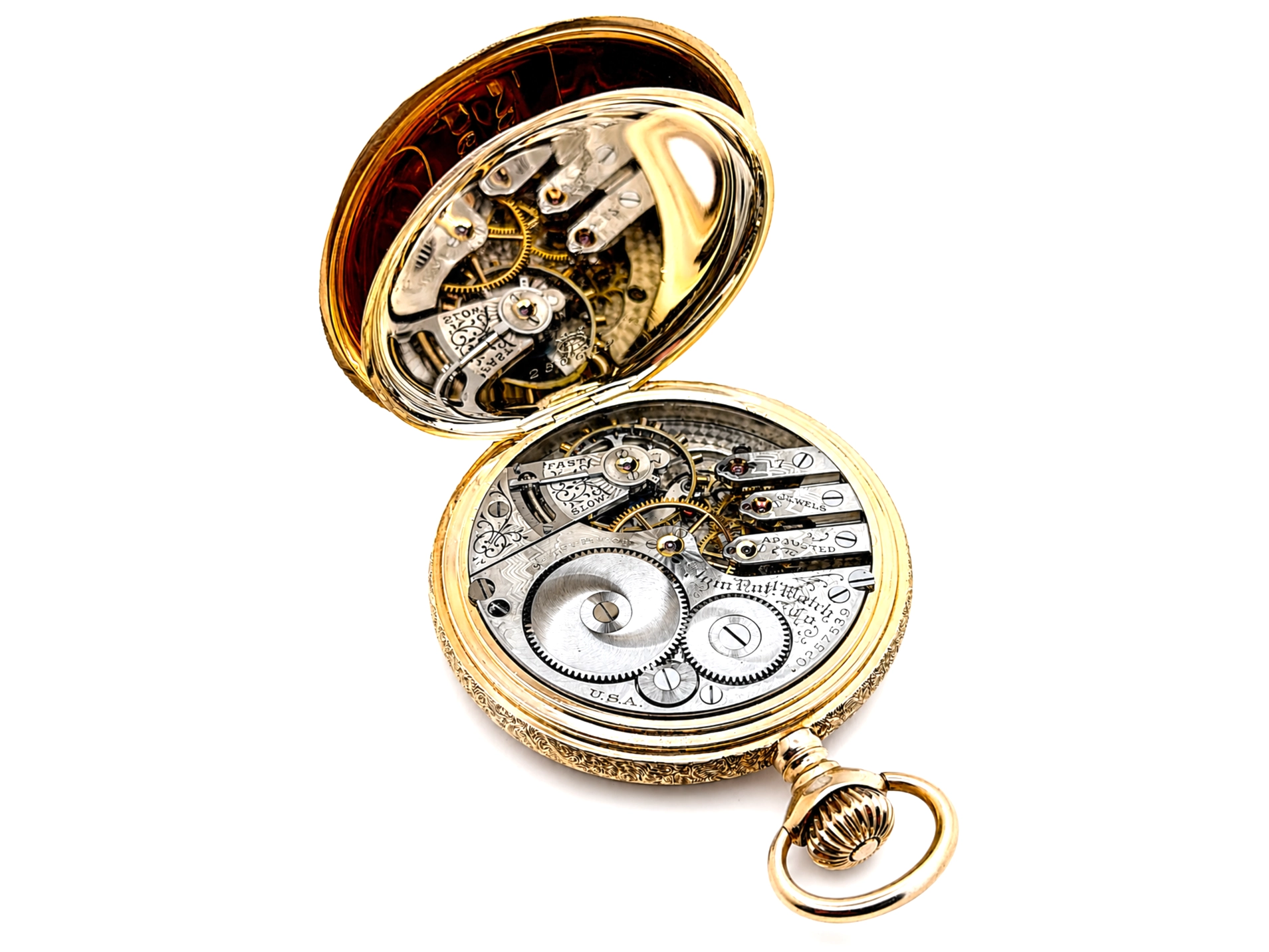 Open gold pocket watch displaying exposed mechanical movement with visible gears, jewels, and balance wheel.