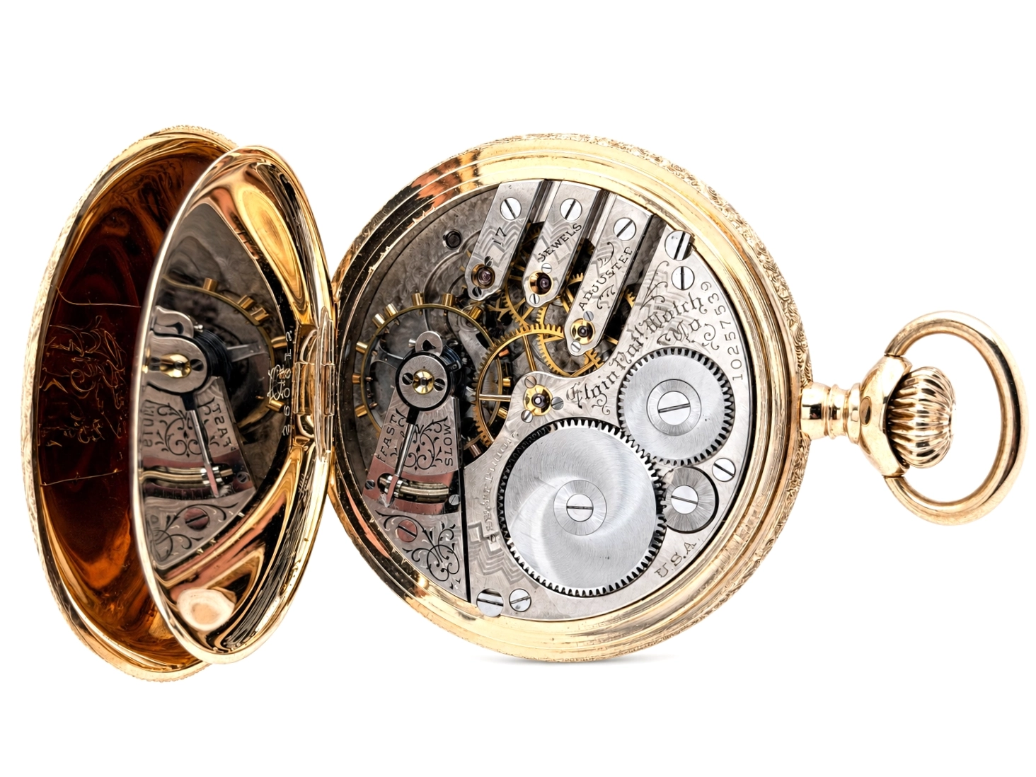 Open-face pocket watch with gold case displaying movement, jewels, and decorated balance cock with engraved cover.