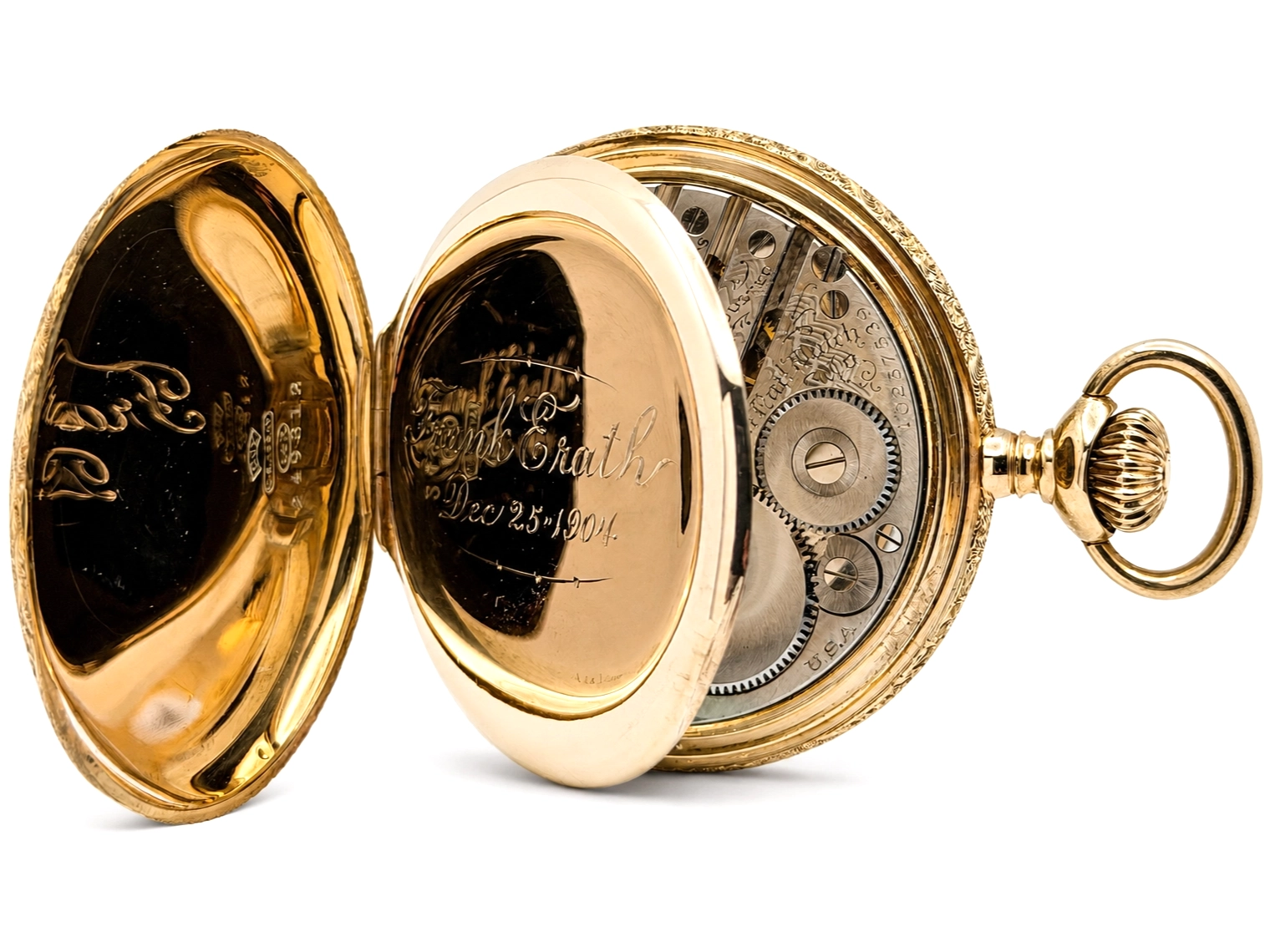 Open-face pocket watch with gold case, engraved cover, and visible movement with jeweled components.