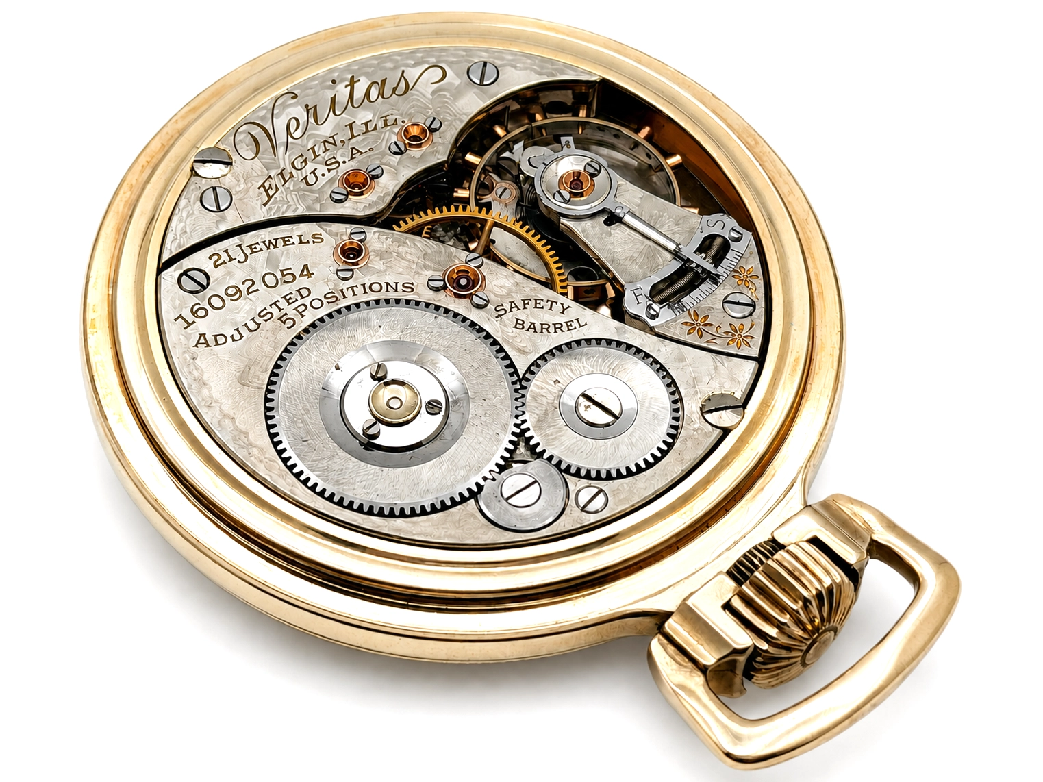Exposed watch movement showing jeweled bearings, balance wheel, and safety barrel mechanism in gold case.