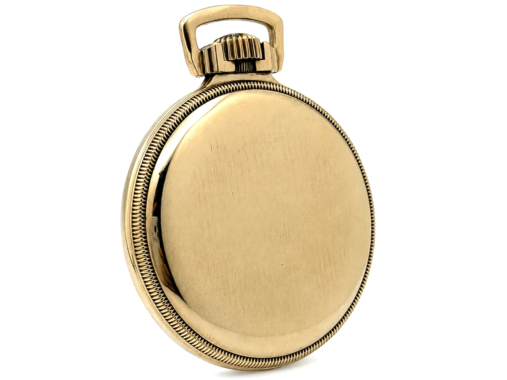 Closed gold pocket watch case back with rope edge bezel and loop crown.