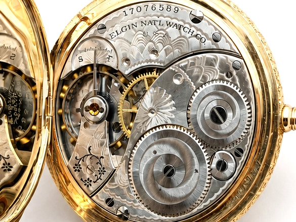 Open pocket watch movement showing Elgin National Watch Co mechanism with visible gears and jeweled plates.