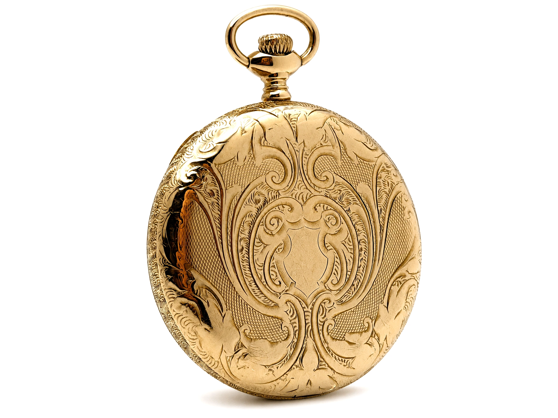 Gold pocket watch case with ornate scrollwork engraving and loop bail, displayed closed.