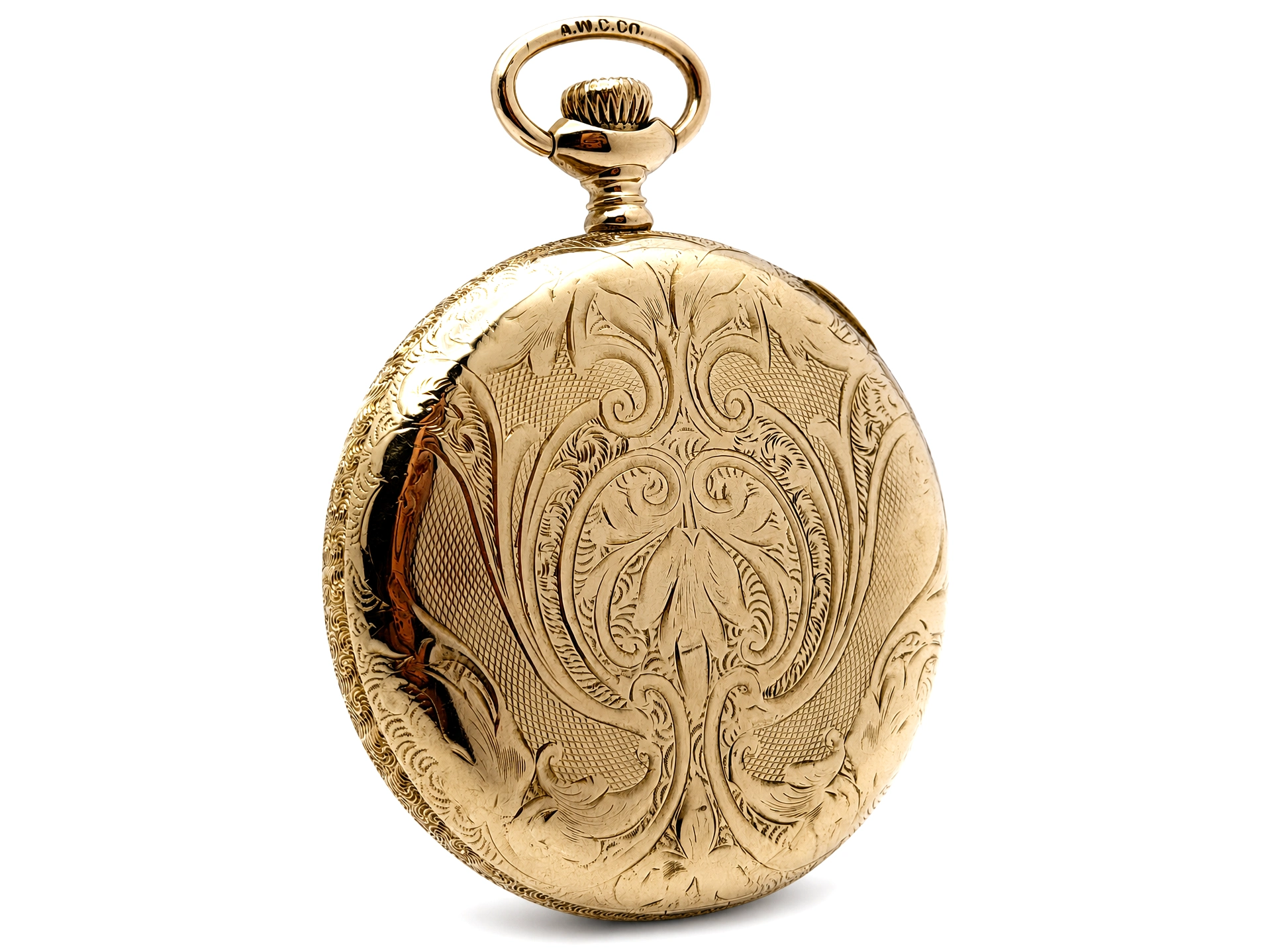 Gold pocket watch case back featuring ornate scrollwork and floral engraving with a decorative loop bail.