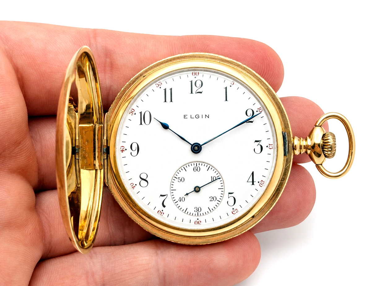 Gold hunter case pocket watch with white dial, Arabic numerals, and subsidiary seconds subdial.
