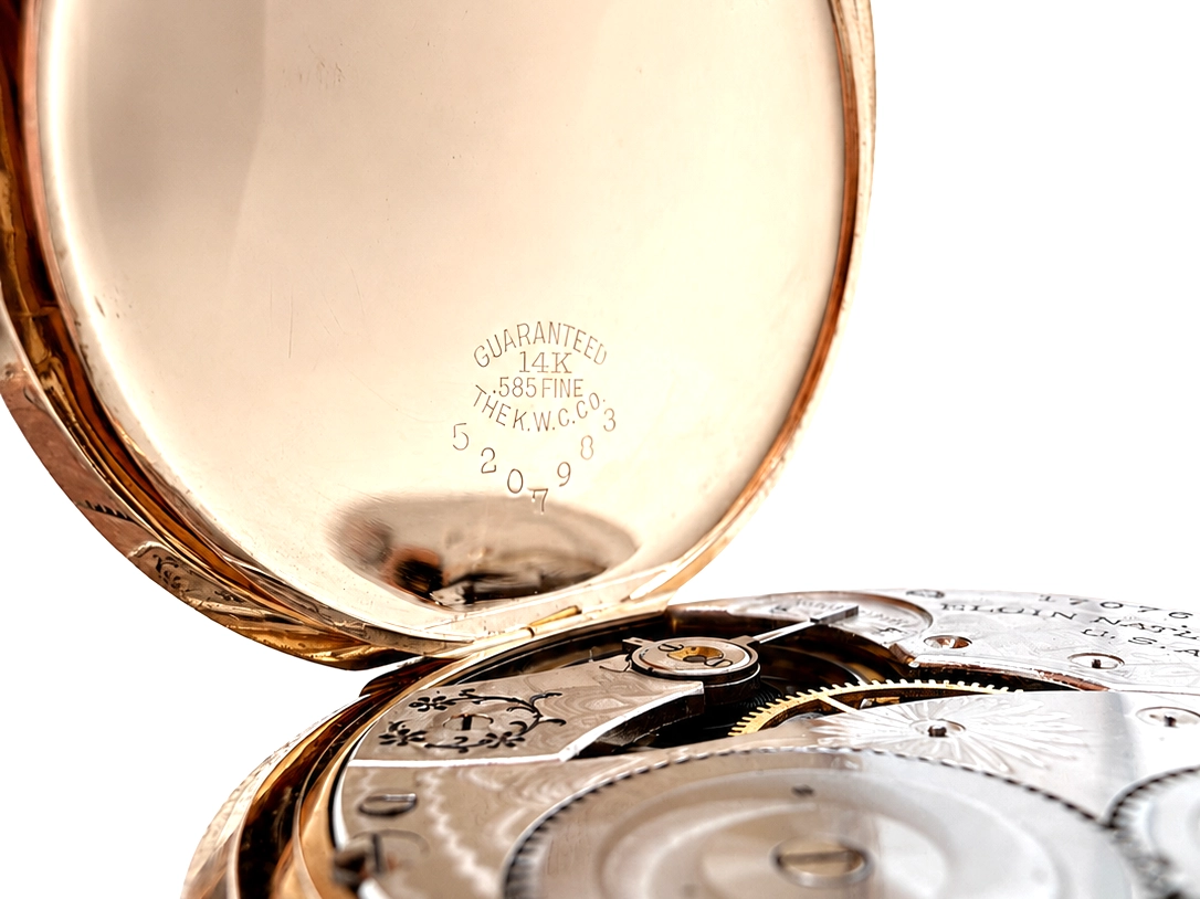 Interior of rose gold case back stamped "Guaranteed 14K .585 Fine" with serial number and maker's mark.