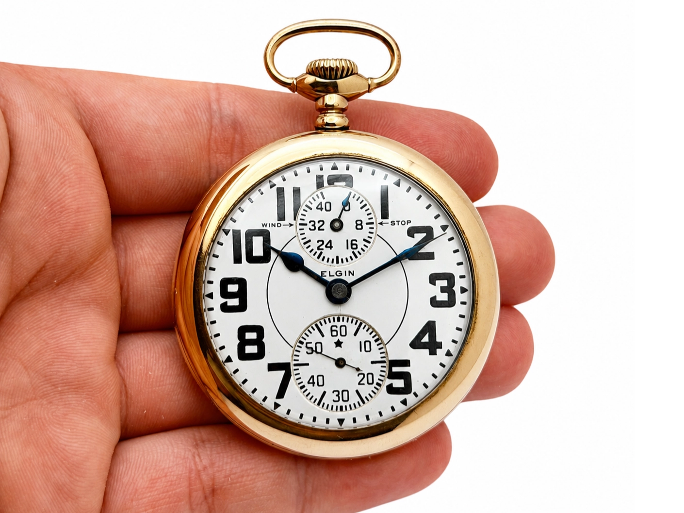 Elgin Veritas 453 Up/Down Wind (1920) — front dial with arabic numerals, two subdials for chronograph functions, and wind/stop indicators