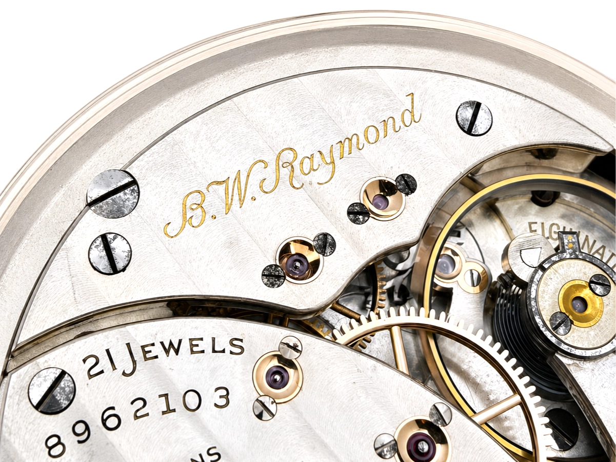 Elgin B.W. Raymond Grade 478 (1926) — open movement showing decorated jeweled bearings, escape wheel, balance wheel, and engraved plate
