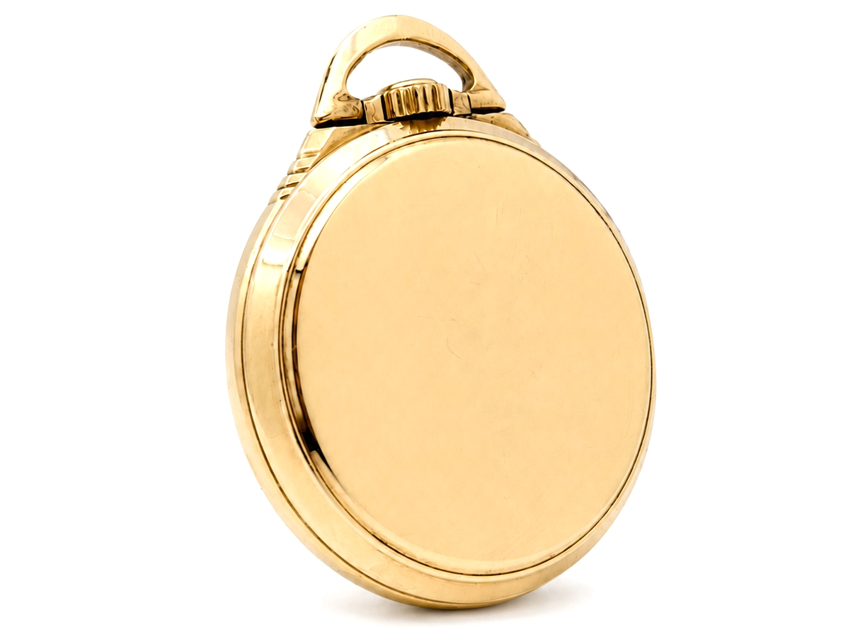 Closed gold pocket watch case with loop handle, shown from front.
