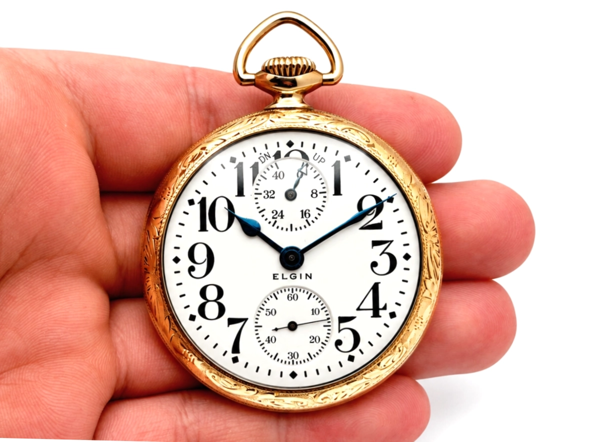 Elgin Father Time 374 with Up/Down Wind Indicator (1917) — front dial with Arabic numerals, subsidiary seconds dials at 12 and 6 o'clock,…