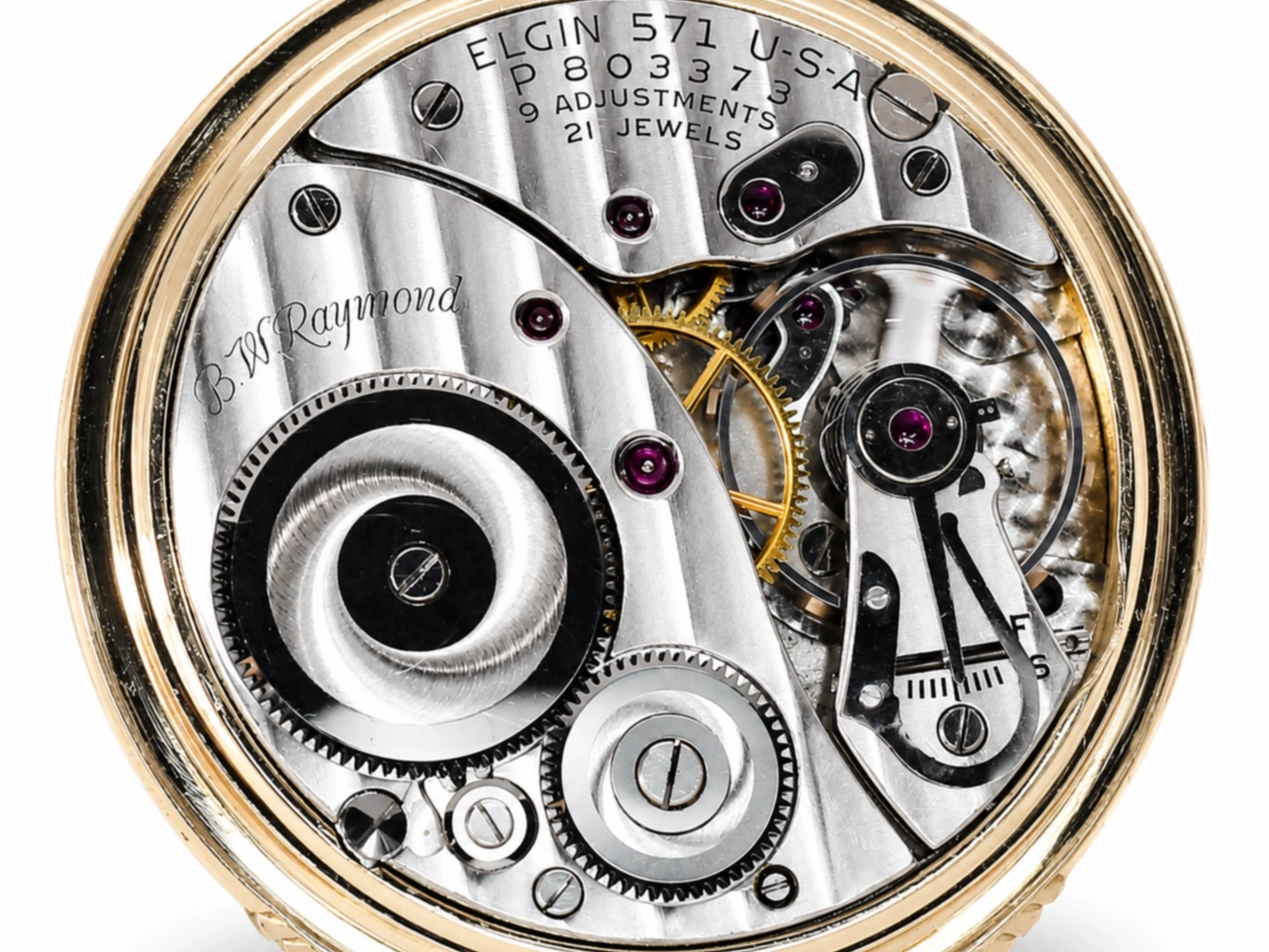 Open watch movement showing Elgin 571 caliber with 21 jewels, balance wheel, and brass gears visible through crystal.