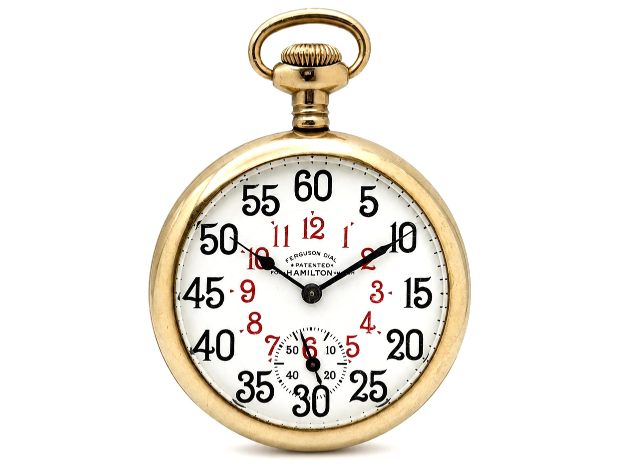 Gold pocket watch with white dial showing chronograph subdial, black Arabic numerals, red minute markers, and black hands.