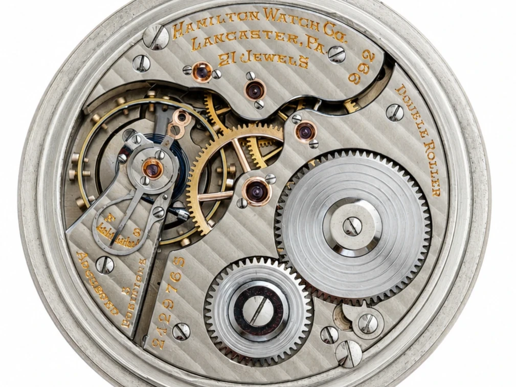 Open movement showing 21 jewels, brass gears, lever escapement, and engraved nameplate.