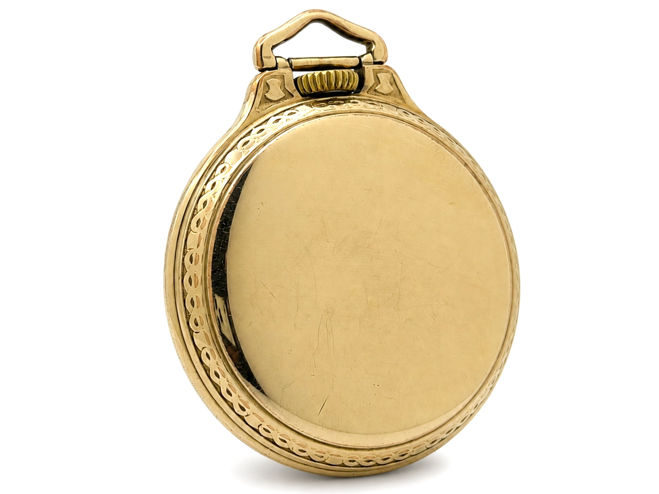 Closed gold pocket watch case back with polished surface and decorative border molding.
