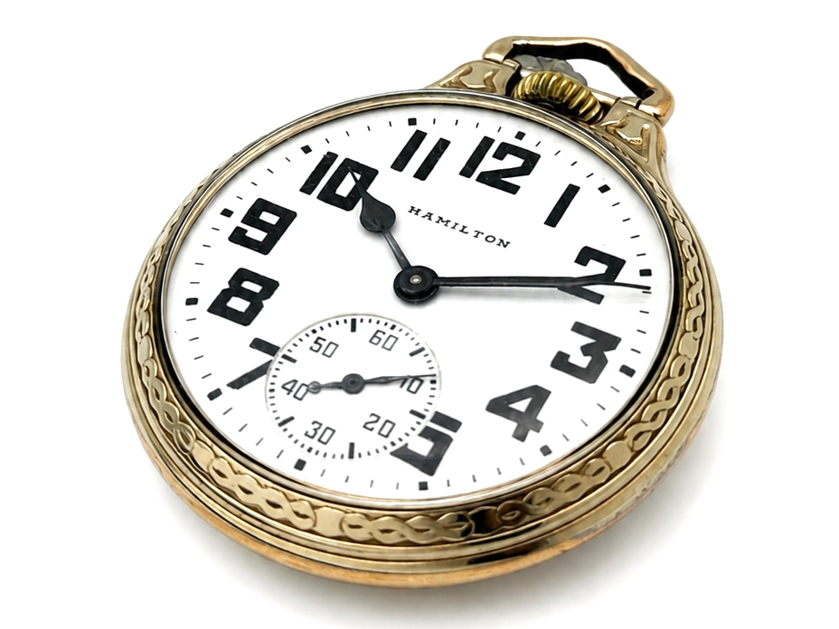 Pocket watch with white dial, bold Arabic numerals, subsidiary seconds dial, and gold-filled ornate case.