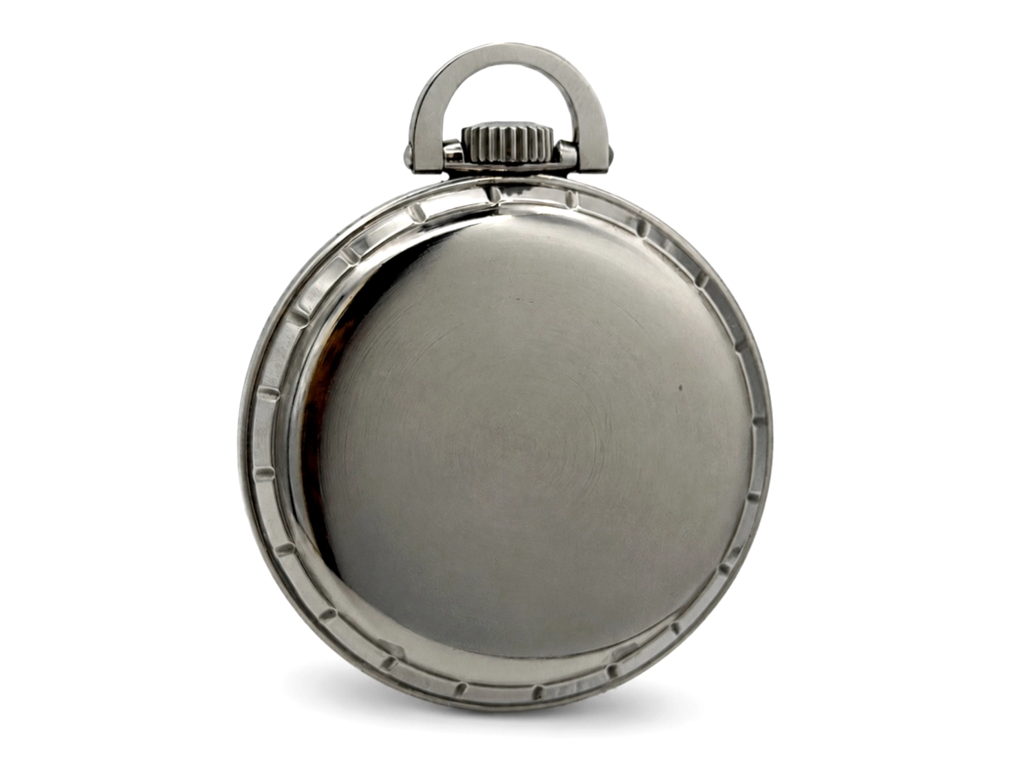 Closed stainless steel case back with segmented edge and bail loop at top.
