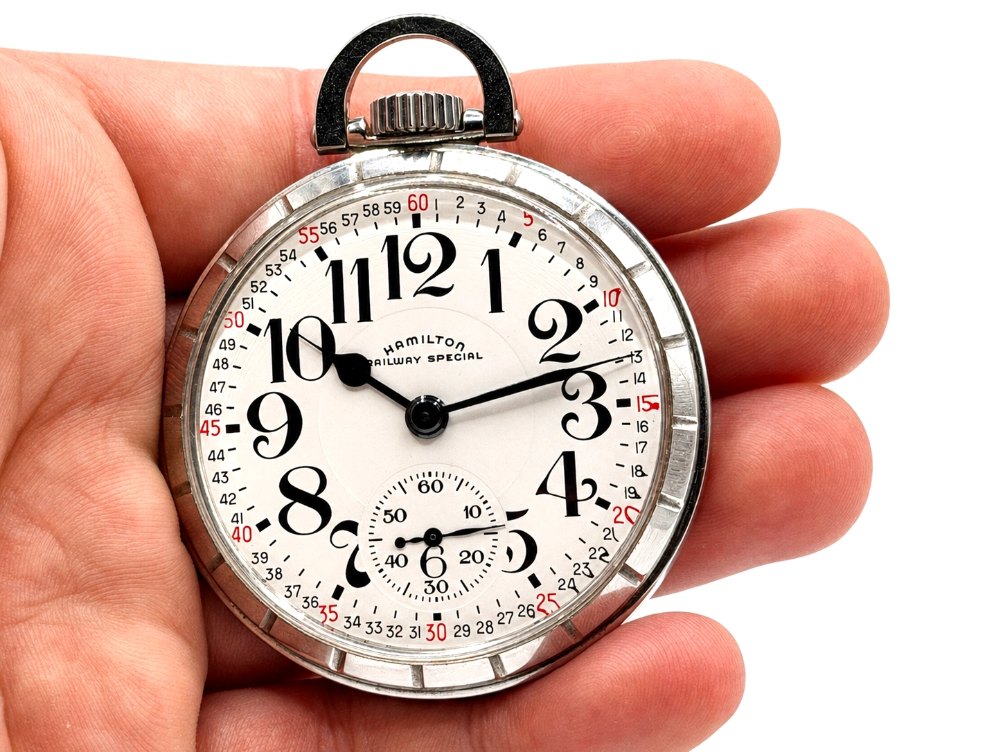 Hamilton Railway Special pocket watch with white dial, Arabic numerals, and subsidiary seconds dial, held in hand.