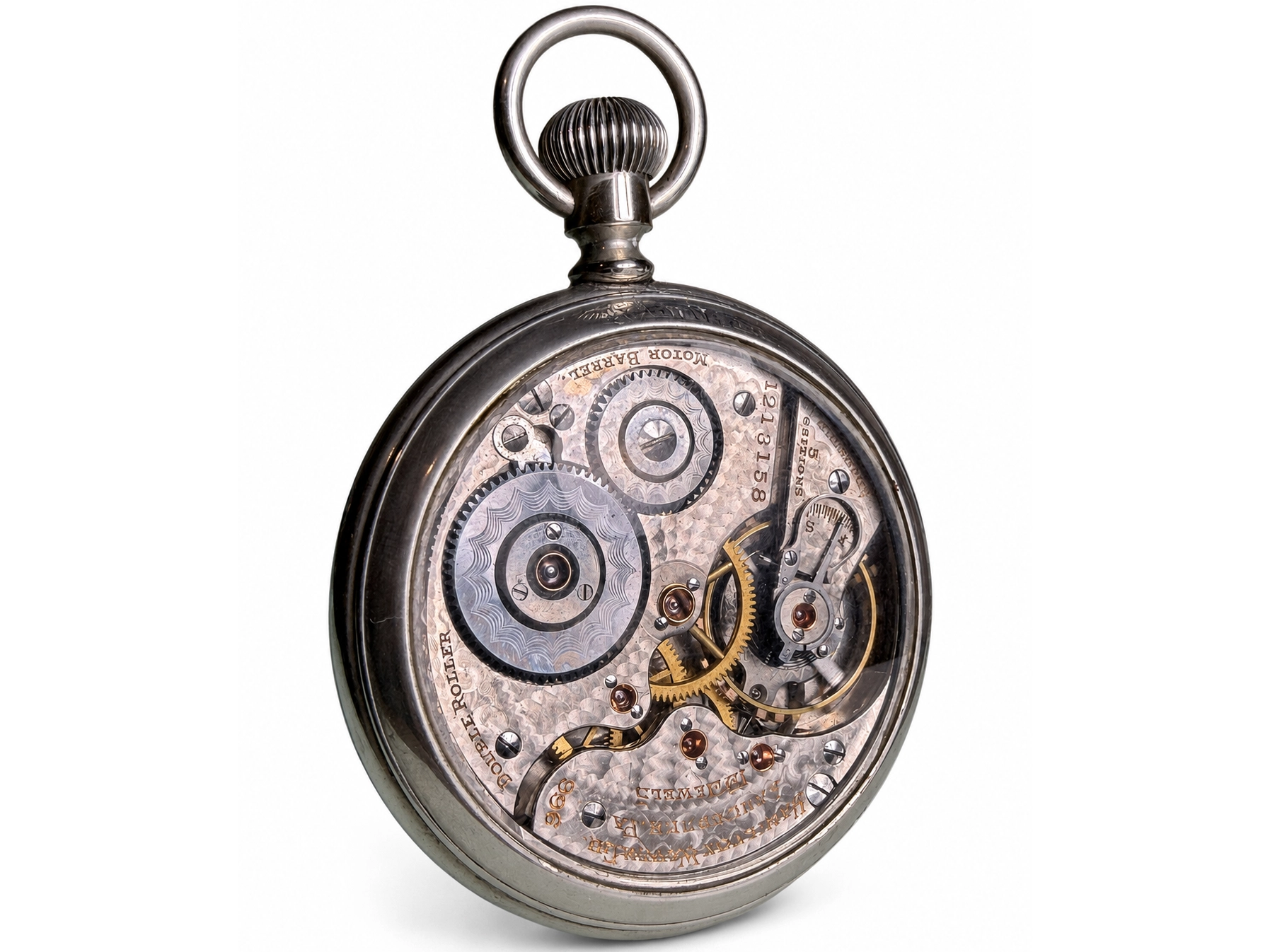 Open pocket watch movement showing visible gears, jewels, and gold-colored balance wheel with polished metal plates.