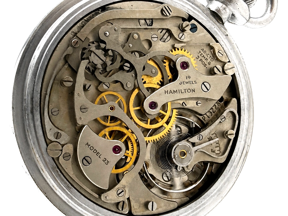 Open pocket watch movement showing golden gears, jewels, and Hamilton Model 23 marked plate.