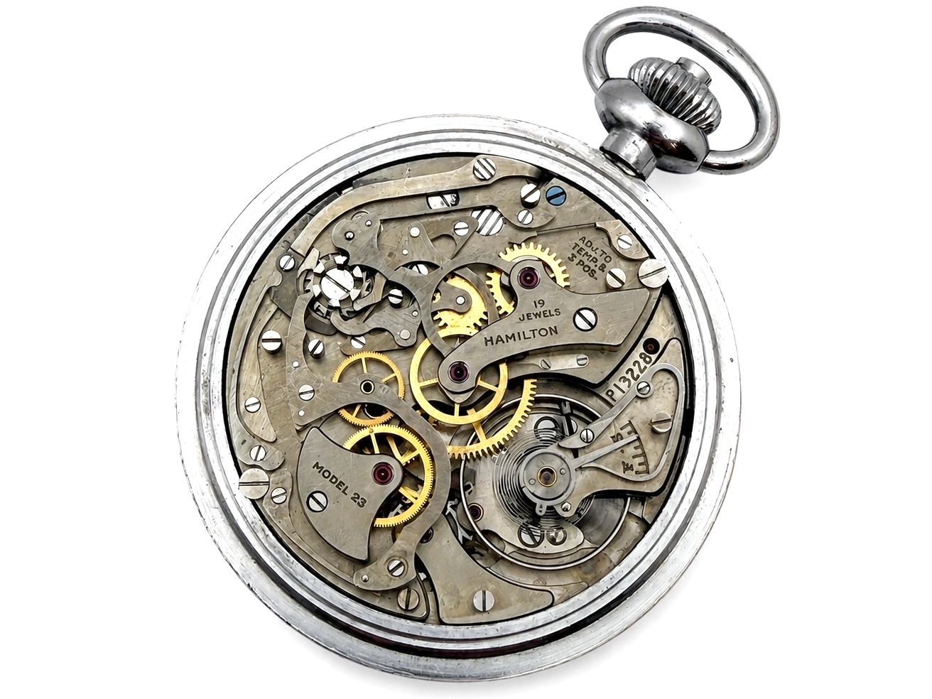 Hamilton pocket watch movement showing jeweled escapement, brass gears, and engraved steel plates.