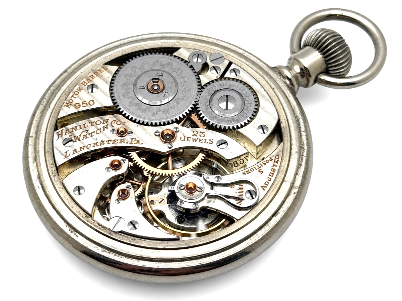 Hamilton 950 Salesman Display Case (1922) — open movement displaying decorated gear wheels, jeweled settings, and balance wheel with…