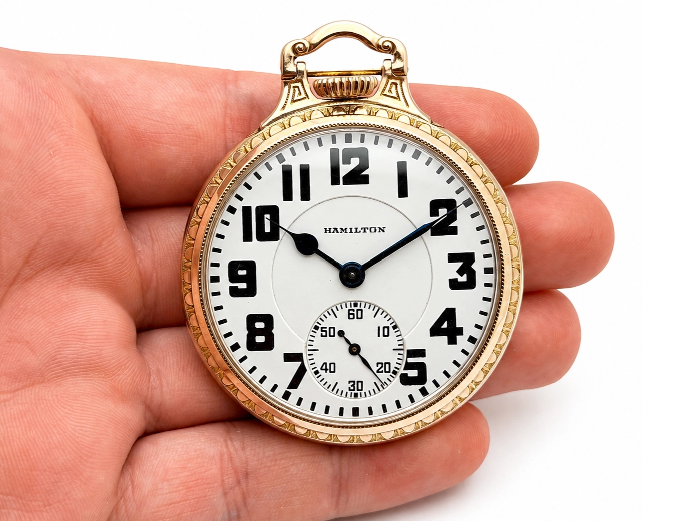 Hamilton Grade 992 (1927) — front dial with applied Arabic numerals, subsidiary seconds dial, black hands, ornate gold-filled case with…