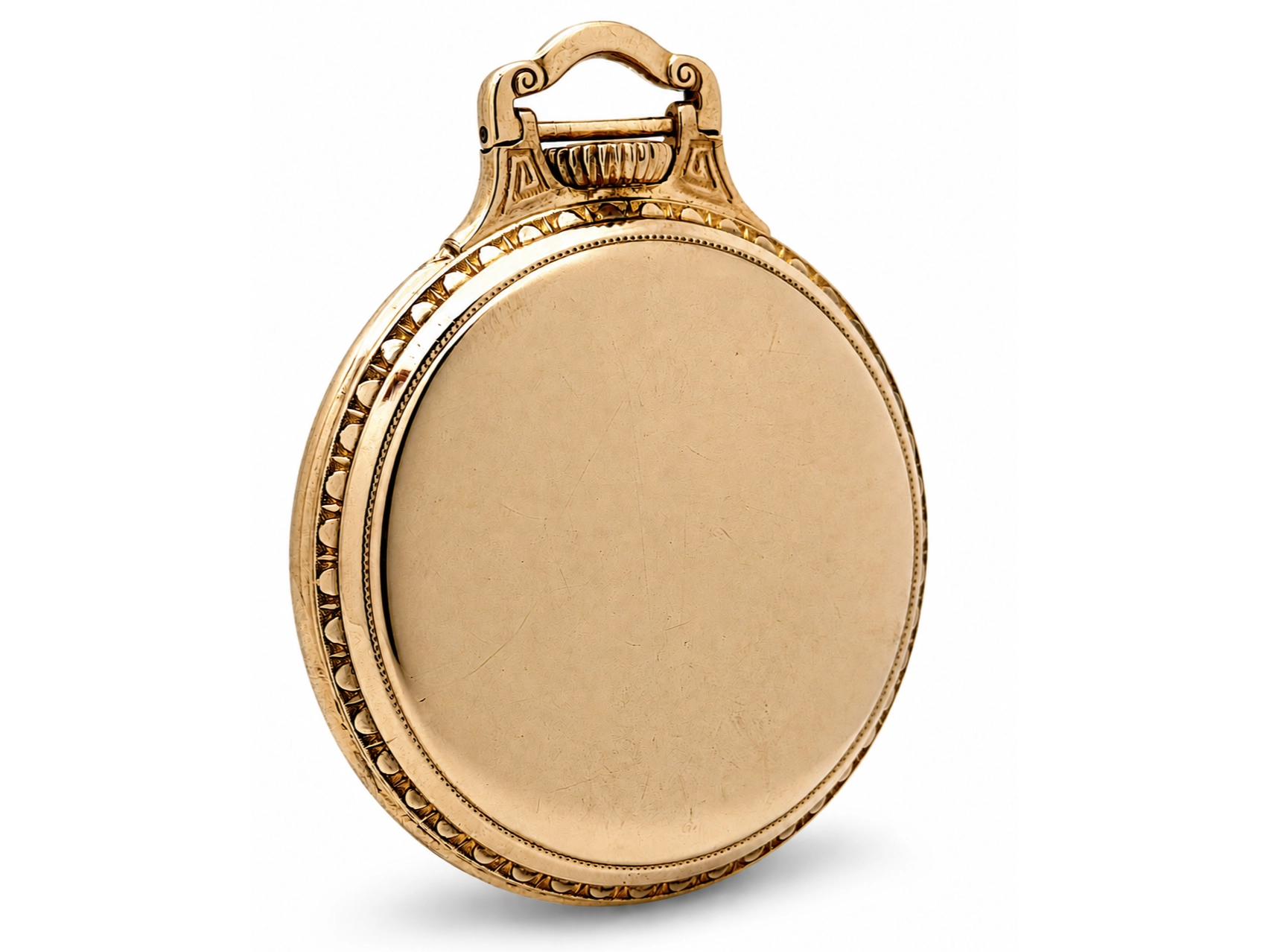 Hamilton Grade 992 (1927) — closed gold case with decorative fluting and beaded edge detail, topped with ornate bow bail