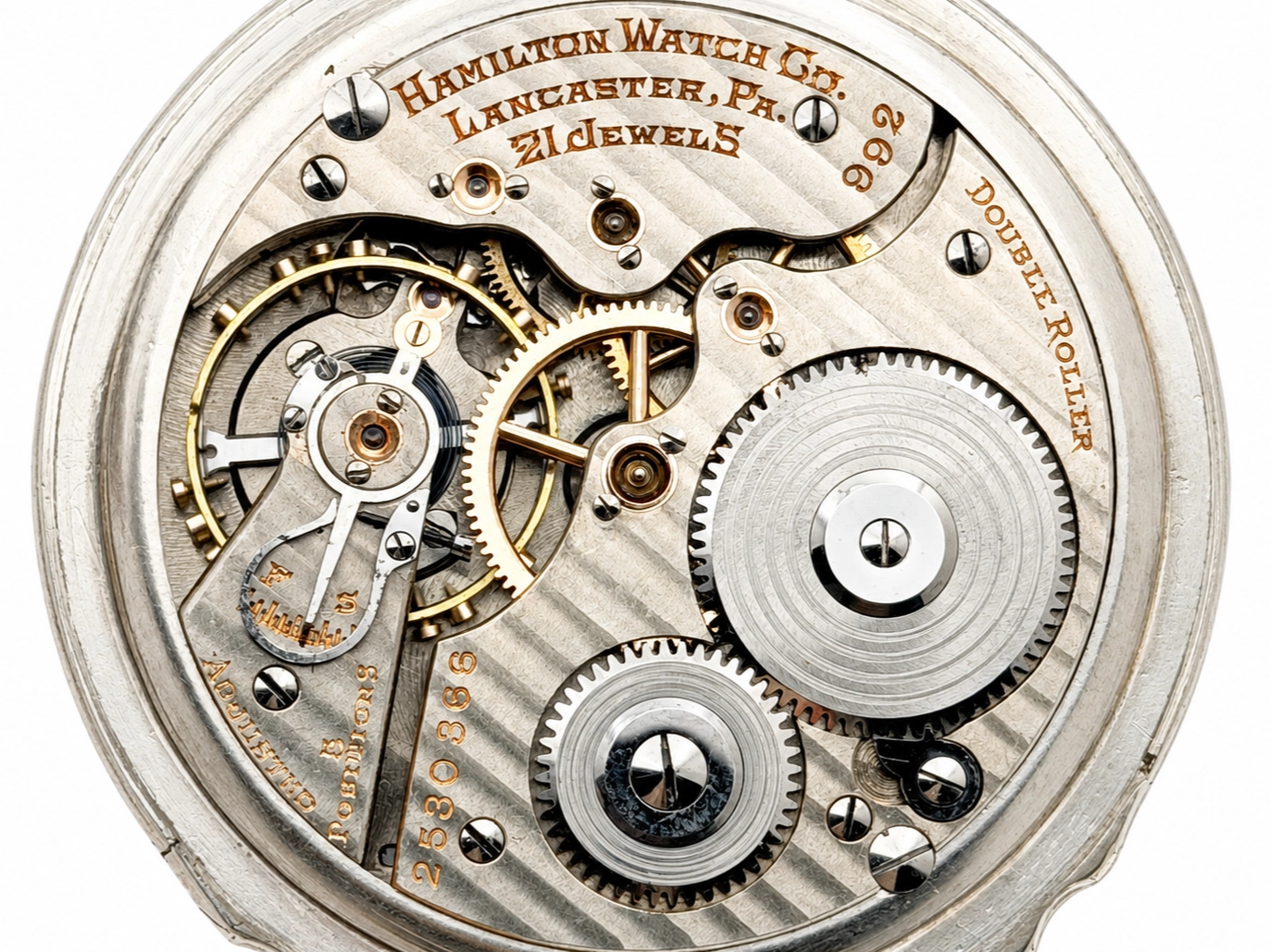 Hamilton 992 (1929) — open movement showing decorated gears, jewels, and balance wheel with engraved plate