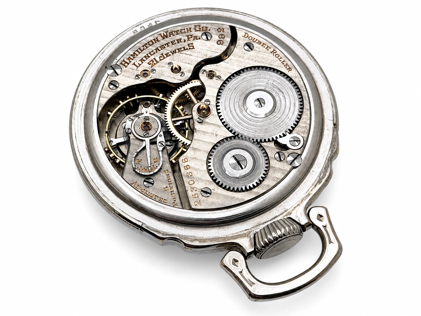 Hamilton 992 (1929) — open movement with double roller, gears, and jeweled balance wheel visible within silver case