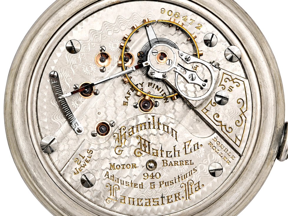 Open pocket watch movement showing jeweled escapement, motor barrel, and gold-filled metal bridge, marked Hamilton.