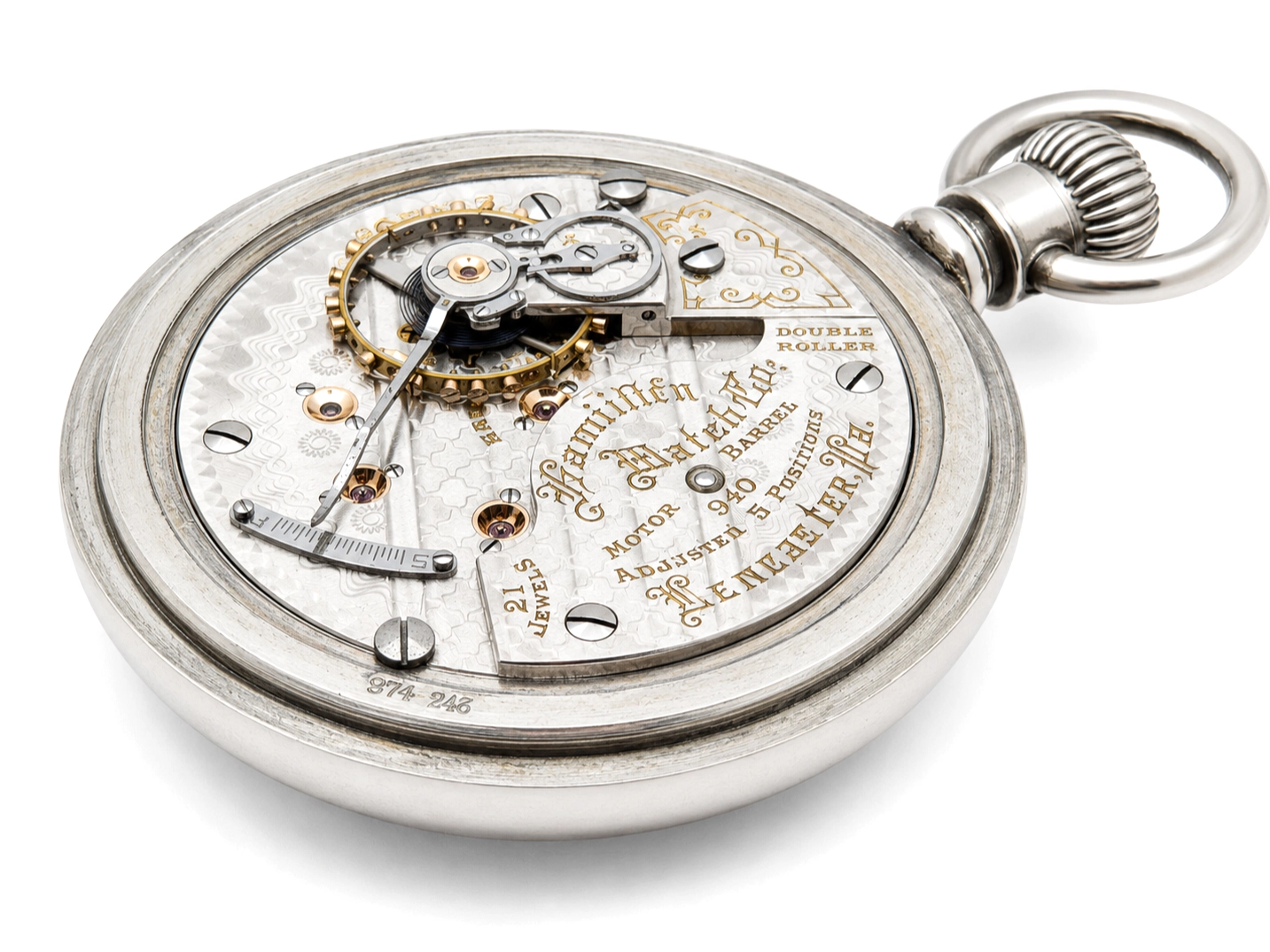 Open movement showing jeweled escapement with double roller, balance wheel, and gilt train wheels on engraved plate.