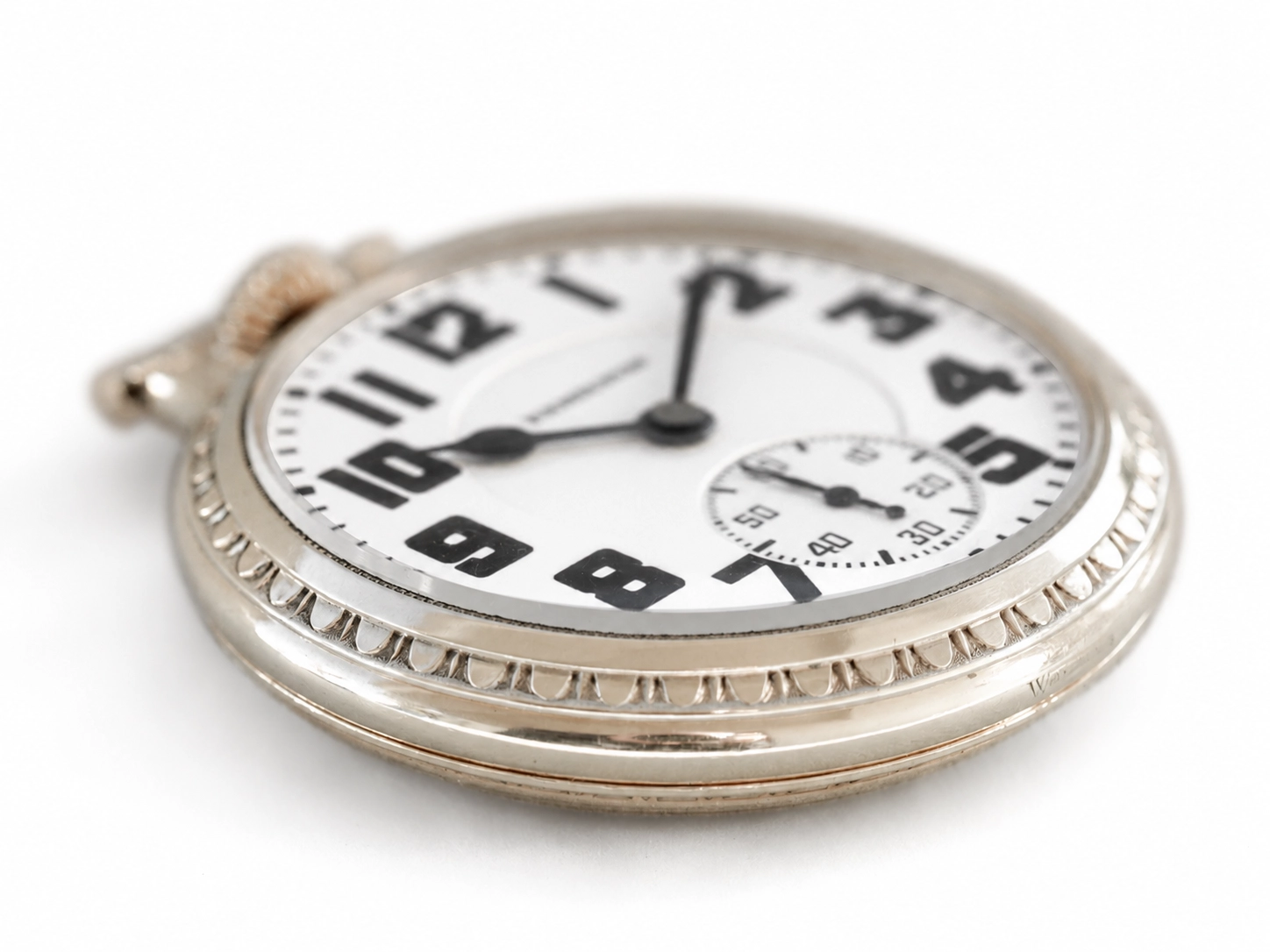 Silver-cased pocket watch with white dial, black Arabic numerals, subsidiary dial, and decorative bezel.