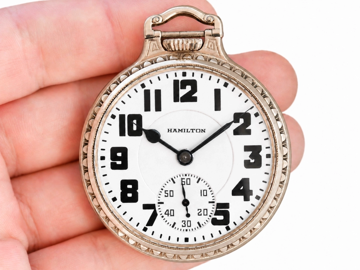 Open-face pocket watch with white dial, bold Arabic numerals, black hands, and subsidiary seconds dial.