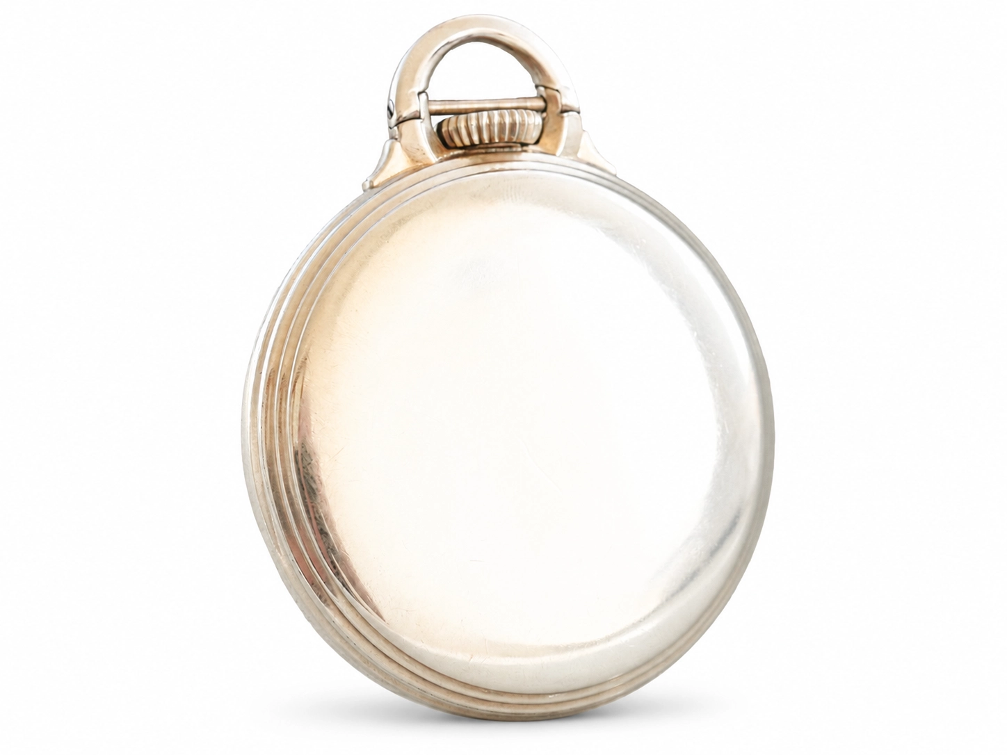 Pocket watch case back with circular crystal window and hinged bail loop, polished metal finish.